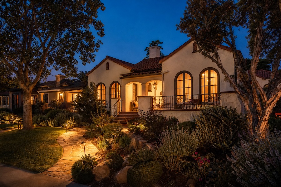 North Park at twilight, with arched windows, a tiled roof, and a warmly lit garden path.